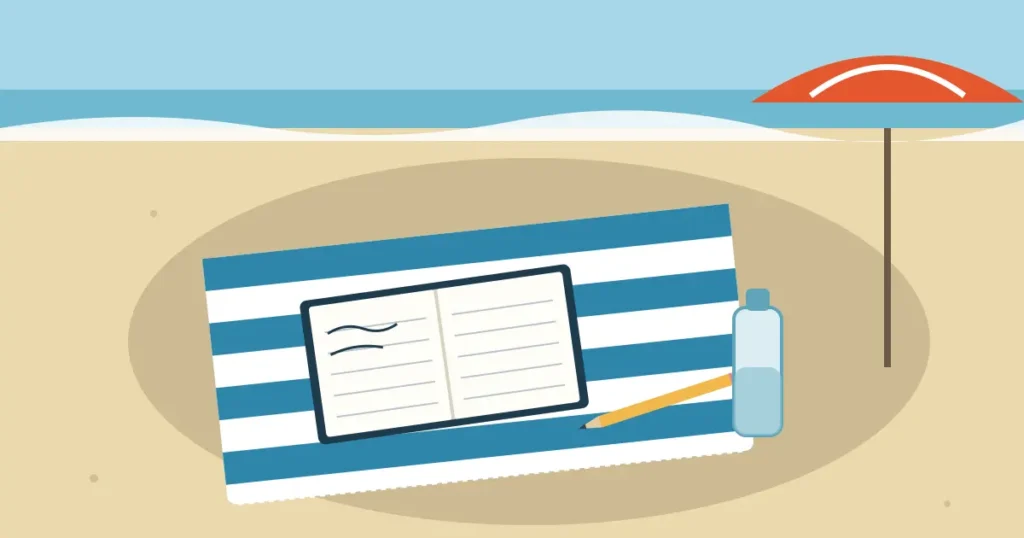Paper notebook and pencil on a beach towel in the shade