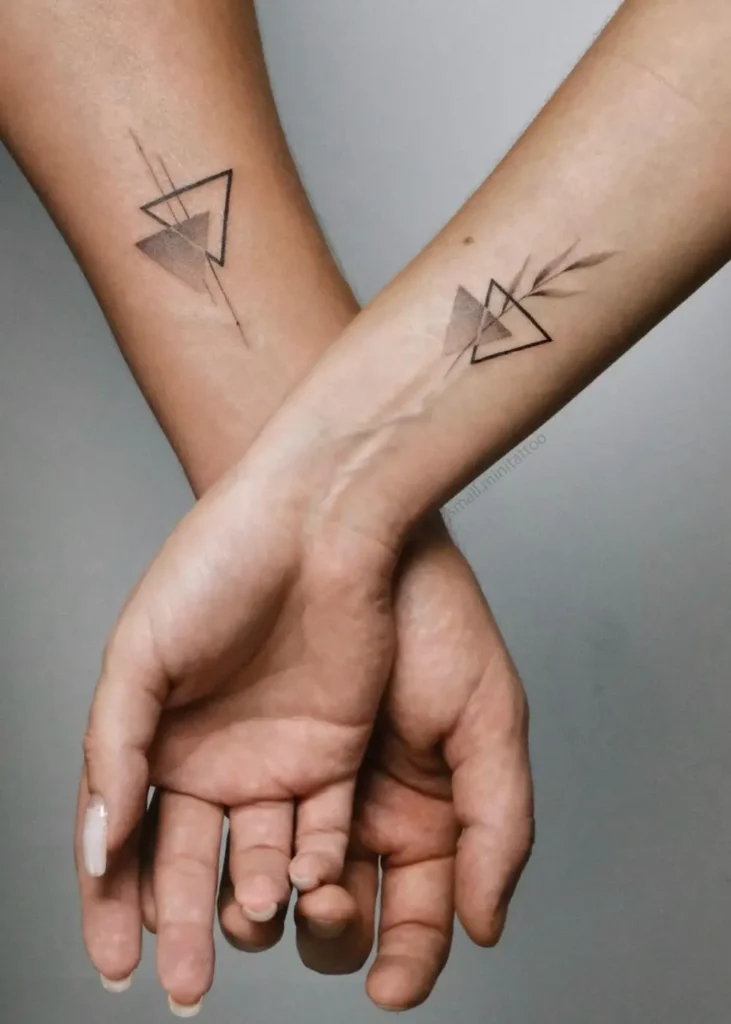 Tiny couple tattoo ideas showing matching ink on hands